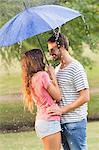 Cute couple hugging under the umbrella