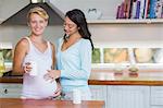 Lesbian woman touching her pregnant girlfriend stomach