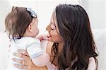 Smiling mother holding her baby girl