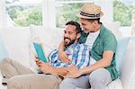 Homosexual couple men reading a book