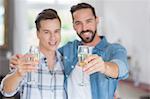 Homosexual couple men toasting with a champagne flute