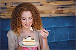 Happy pretty woman taking a piece of cake