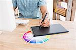 Casual businessman working with digitizer and colour chart