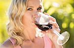 Portrait of blonde woman drinking red wine