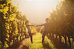 Couple holding hands and leaning back between grapevine