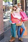 Beautiful women holding shopping bags looking at camera