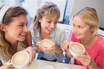 Beautiful women drinking coffee and looking at each other