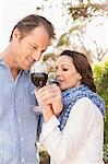 Cute couple drinking wine in a park