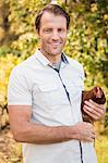 Happy farmer holding chicken