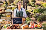 Woman selling organic vegetables at market