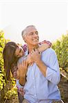 Smiling woman putting arms around her man