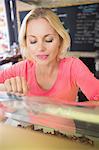 Pretty blonde choosing a cake