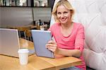 Woman having a coffee using tablet