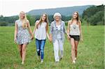 Portrait of Grandmother with Granddaughters Walking Hand in Hand Outdoors, Bavaria, Germany