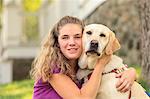 Woman with visual impairment hugging  her service dog