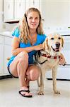 Woman with visual impairment in kitchen with her service dog