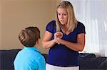 Mother and son with hearing impairments signing 'work' in American sign language