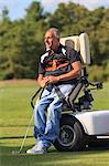 Man with a spinal cord injury in an adaptive cart about to play golf
