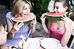 Mother and daughter eating watermelon