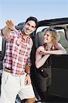 Man giving woman in jeep directions