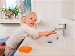 Toddler girl washing her hands