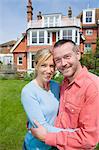 Couple hugging in backyard