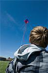 Boy flying a kite in field