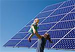 Woman and daughter by solar panel