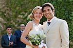 Newlyweds at marriage ceremony, looking away