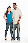 Mixed race couple standing against white background