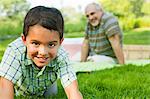 Grandson smiling in park, portrait