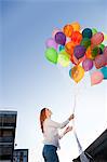 Young woman outdoors with balloons