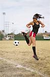 Soccer player practising in field