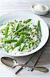 Still life of pea risotto with parmesan cheese and pepper