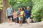 Multi-generation family walking in woods