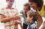 Family watching butterfly in jar