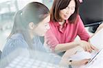 Businesswomen discussing paperwork in office