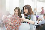 Fashion designers examining dress