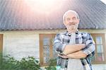 Portrait confident senior farmer outside farmhouse