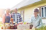 Grandparents and grandson selling honey