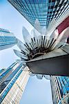 Glass and metal Lotus installation in front of HSBC Bank with surrounding new skyscrapers in Jianggan district, Hangzhou, Zhejiang, China, Asia