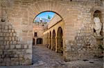 Medieval Dalt Vila fortress arch gate, columns and statue. Eivissa, Spain