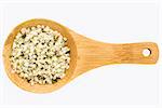 hemp seed hearts on a small wooden spoon isolated on white with a clipping path