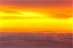 Sunset with clouds over view from airplane flying