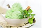 Scoop of matcha ice cream in bowl on wooden vintage background.