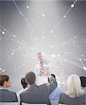 Businessman doing speech during meeting  against grey background