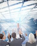 Business people raising their arms during meeting  against glowing world map on black background