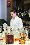 Young woman mixing a cocktail at a bar in a city restaurant.