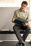 Businessman reading newspaper in waiting room