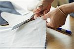 Woman cutting fabric, cropped